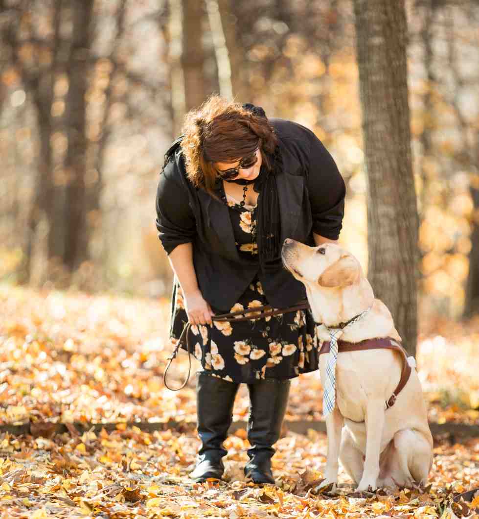woman and guide dog outside in leaves